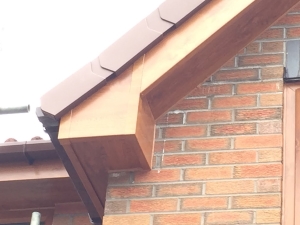Light Oak uPVC Fascia & Soffits with a brown square guttering and brown dry verge.