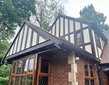 Replica wood Tudor boards installed on a house by Roofline Design UK showing authentic Tudor-style cladding.