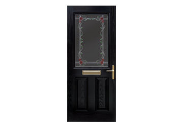 Black door with decorative glass panel featuring a floral design and a gold-colored door handle.
