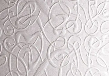 Textured white wall with swirling, embossed patterns.
