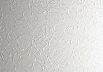 Textured white wall with floral pattern relief.