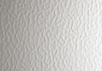 Textured white surface with a wavy pattern.