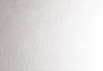 White textured wall with floral patterns.