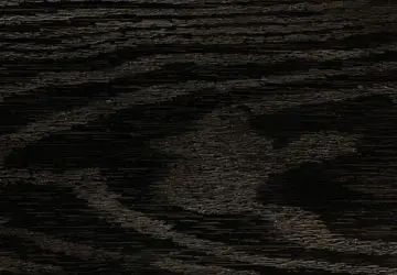 Dark wooden surface with grain patterns and a faint, unclear outline in the center.