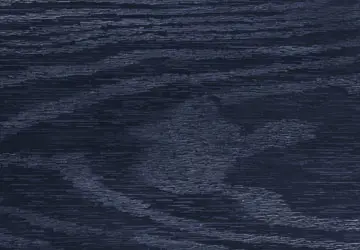 Dark wood surface with visible grain patterns and subtle lighter markings.