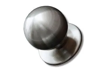 Silver door knob with a round, smooth design and a flat base.