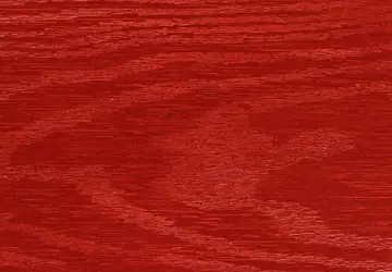 Red wooden surface with a textured grain pattern.